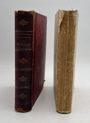 two old books sitting side by side on a white surface