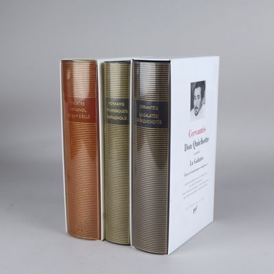 three books are stacked on top of each other on a table