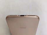 the back of a gold iphone 6s sitting on top of a white table