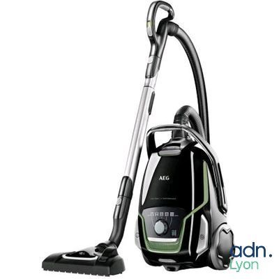 a close up of a vacuum cleaner with a black and green handle