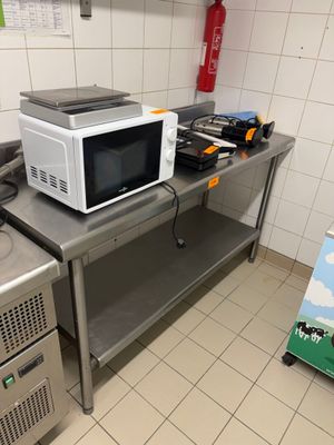 a microwave and a stove in a small kitchen