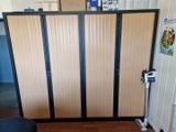 a room divider in the middle of a room with a chair and a table