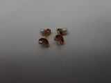 a pair of gold earrings on a white surface