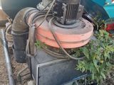 a machine that is sitting on the ground next to a truck