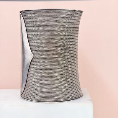 a close up of a vase on a white pedestal