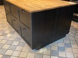 a large kitchen island in the middle of a tiled floor