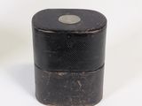 a small black box sitting on a white surface