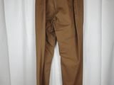 brown pants hanging on a white curtain in front of a white curtain