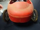 a red toy car that is sitting on a black table