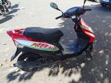 a motor scooter parked in a parking lot