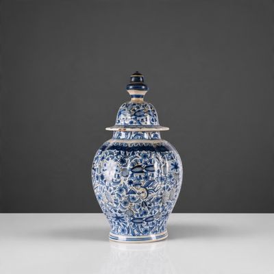 un vase bleu et blanc avec un couvercle sur une table