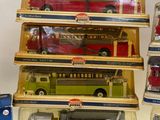 five different types of toy buses in a display case