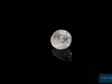 a close up of a white diamond on a black surface