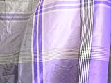 a purple and white checkered scarf hanging on a wall
