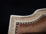 a close up of a chair with pearls on it