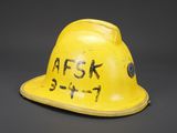 an old yellow fire helmet with the words ask no written on it
