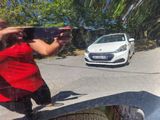 reflection of a person taking a picture of a car in a mirror