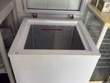 a freezer that is sitting in the corner of a kitchen