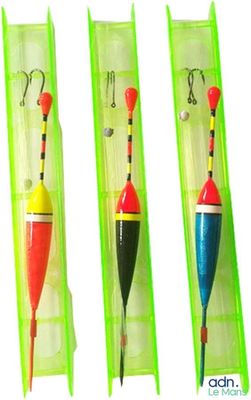 four different colored fishing lures in a plastic case