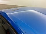 a close up of a blue car with the hood up