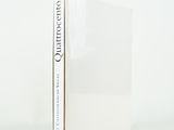 a white book sitting on top of a table next to a white wall