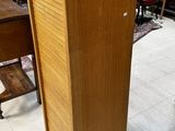 a tall wooden cabinet in the middle of a room