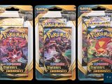 three packs of pokemon trading cards are shown on a black background