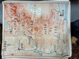 a map on a table with a person standing next to it