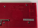 an image of a red electronic device on a white surface