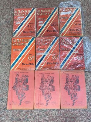 six books on a carpeted floor, one of which is red and one of which is blue and white