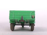 a green toy truck with a man sitting in the back of it