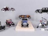 a lot of different model cars on display in a display case