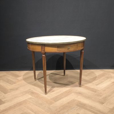 an image of a small table with a marble top on a wooden floor