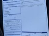 two papers that are sitting on the seat of a car