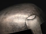 a close up of a metal object on a black background