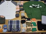 a table with a lot of clothing and accessories on it