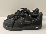 black nike air force low sneakers on a white surface
