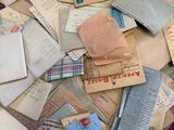 a pile of old letters and envelopes on the ground