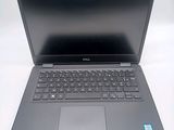 a dell laptop computer sitting on a white surface