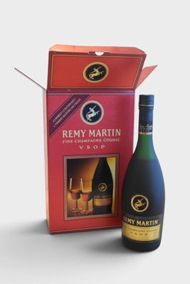 the bottle of wine is next to a box of wine