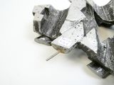 a piece of metal that has been cut in half and is sitting on a white surface