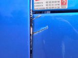 a blue refrigerator with a no smoking sign on it
