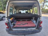 a car that has a bed in the back of it