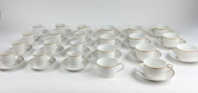 a lot of cups and saucers sitting on a table