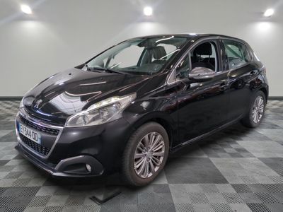 the black car is parked on a checkered floor in the garage
