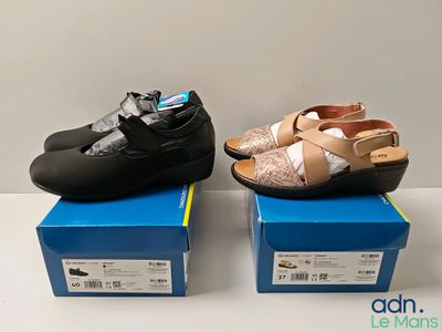 two pairs of women ' s shoes sitting on top of boxes