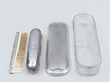 a silver case with a comb and a comb in it