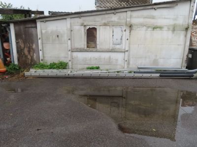 a reflection of a building in a puddle of water