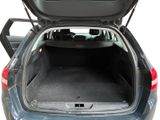 the back of a car with its trunk open and the back seats folded down