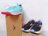 une paire de chaussures de course bleues et roses posée sur une boîte en carton